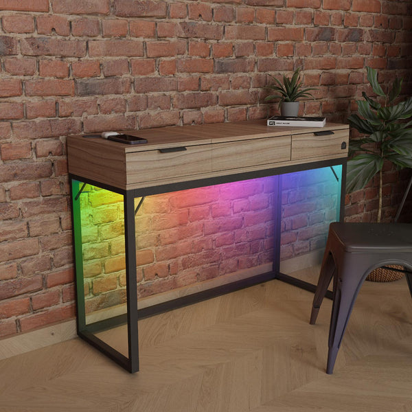 Wooden vanity table with colorful LED lighting against a brick wall