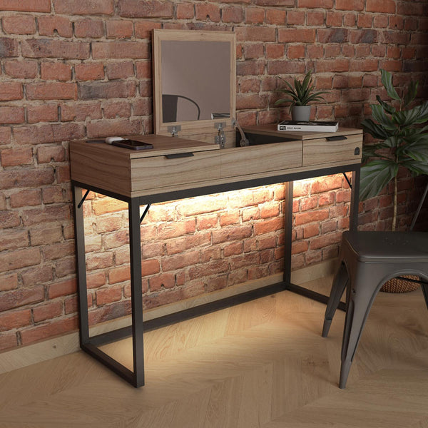 Wooden vanity table with mirror against a brick wall