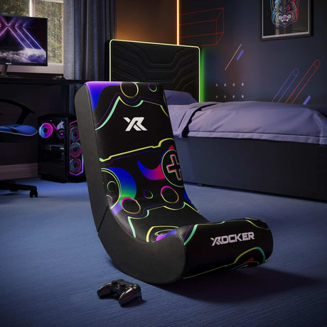 Gaming chair with colorful design in a room setup with a TV and gaming accessories.