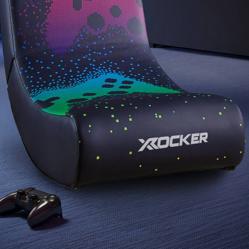 Gaming chair with colorful design and X rocker logo on a blue surface.