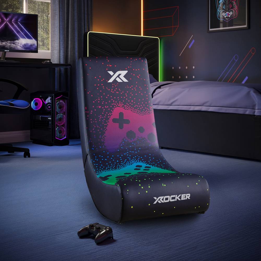 Gaming chair with X rocker logo in a room setup with gaming equipment.