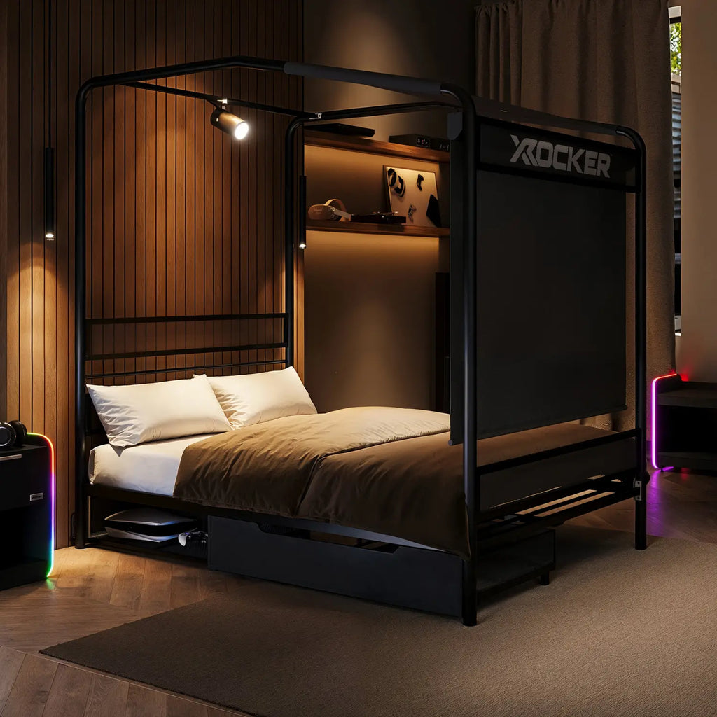 Black framed bed with X rocker branding in a dimly lit room.
