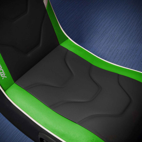 Close-up of a gaming chair with green and black design on a blue textured background